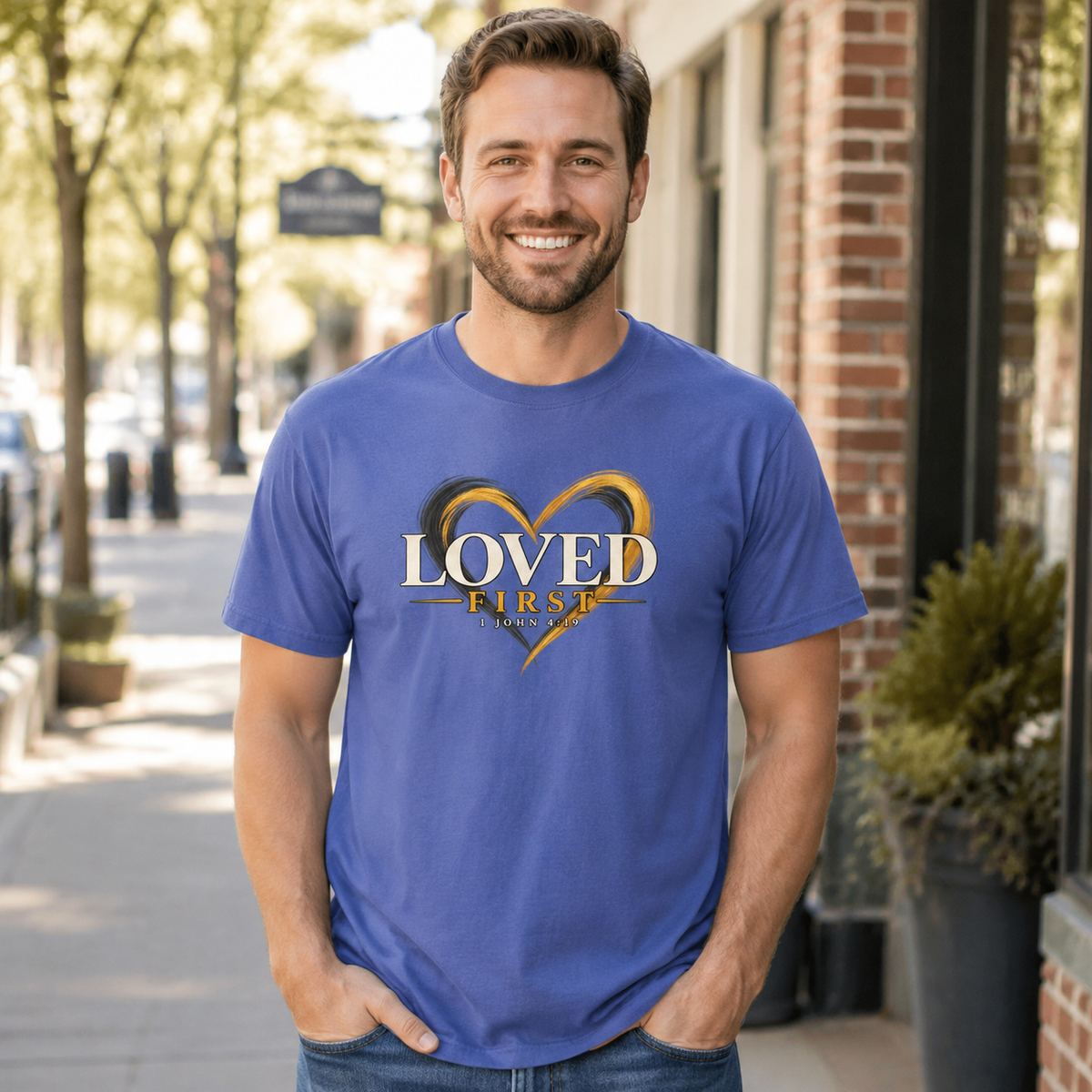 Man wearing the He First Loved Us 1 John 4:19 Christian T-shirt in Mystic Blue