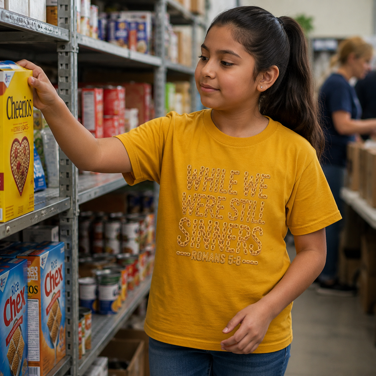 Youth wearing While We Were Still Sinners Romans 5:8 Christian T-shirt at a food pantry