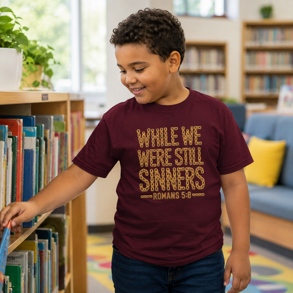 Youth wearing While We Were Still Sinners Romans 5:8 Christian T-shirt in a library